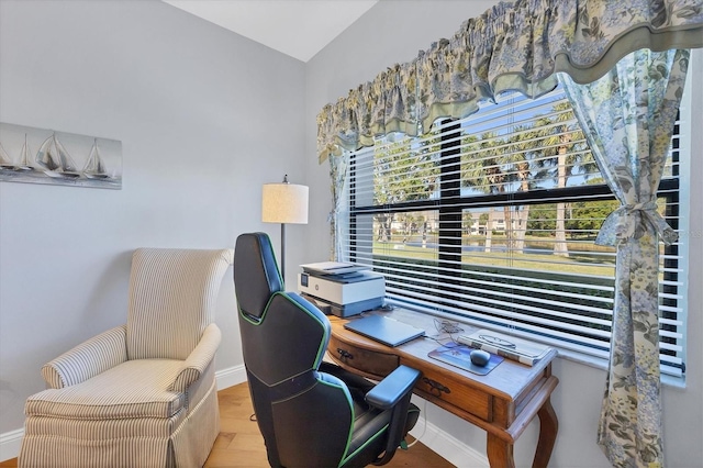 office area with hardwood / wood-style floors and vaulted ceiling