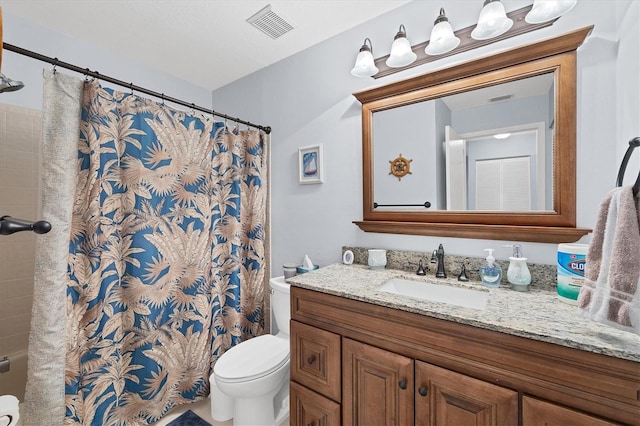 bathroom with vanity, toilet, and walk in shower