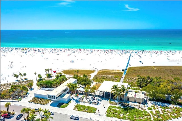 aerial view with a water view and a view of the beach