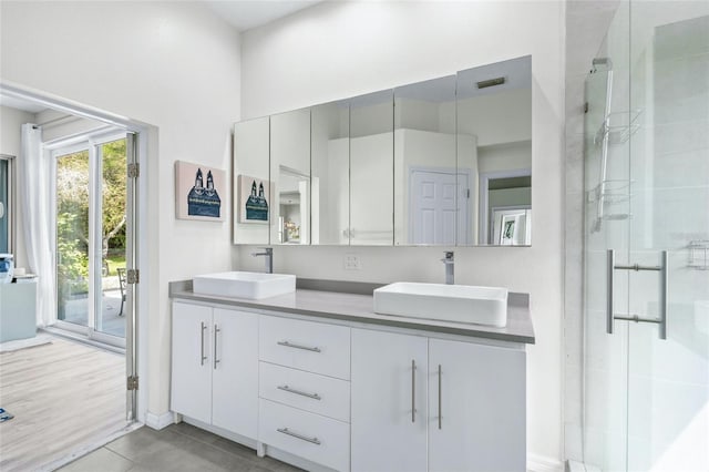 bathroom with vanity, tile patterned floors, and walk in shower