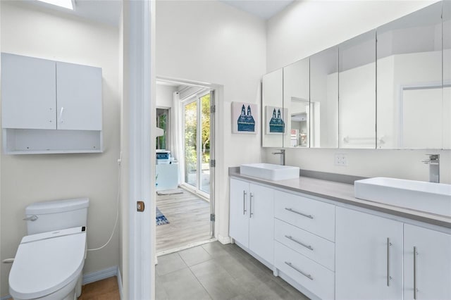 bathroom with vanity, toilet, and tile patterned flooring