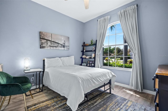 bedroom with dark wood-type flooring and ceiling fan