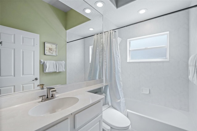 full bathroom featuring vanity, shower / bath combination with curtain, and toilet