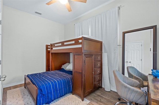 bedroom with light hardwood / wood-style floors and ceiling fan