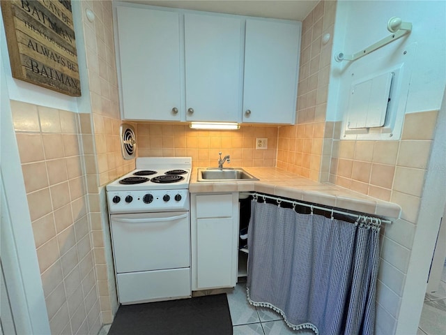 kitchen with white cabinetry, sink, tasteful backsplash, white range, and tile countertops