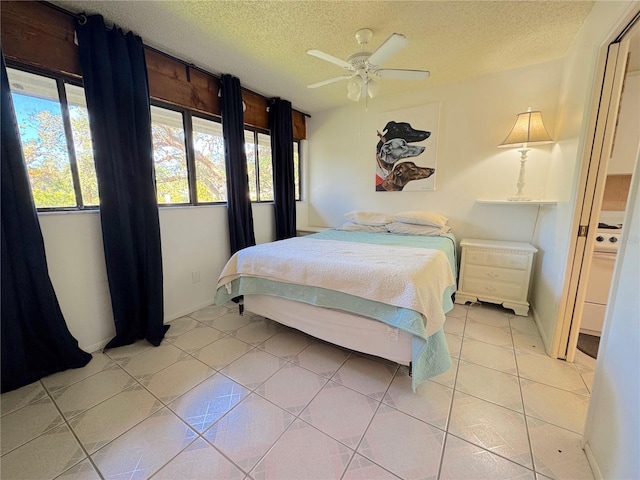 tiled bedroom with a textured ceiling and ceiling fan