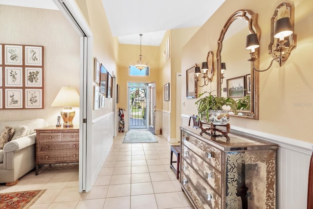 foyer with lofted ceiling and light tile patterned floors