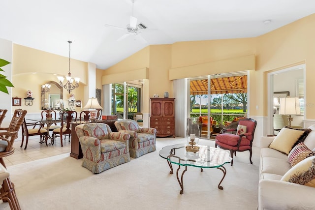 living room with light carpet, ceiling fan with notable chandelier, high vaulted ceiling, and plenty of natural light