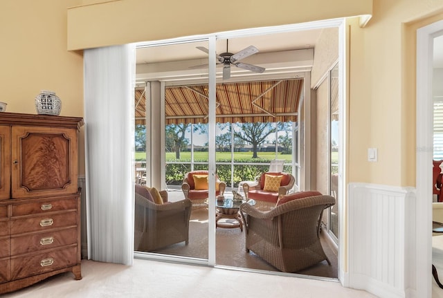 sitting room featuring light carpet and ceiling fan