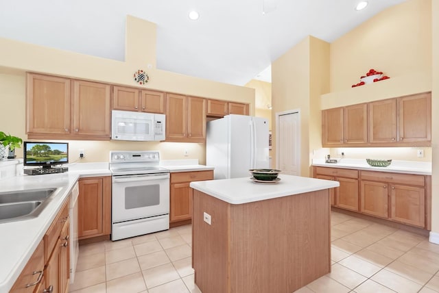 kitchen featuring sink, a kitchen island, a towering ceiling, white appliances, and light tile patterned floors