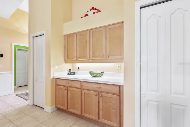 bathroom with tile patterned flooring and a towering ceiling