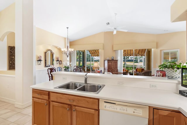 kitchen with ceiling fan with notable chandelier, sink, light tile patterned floors, dishwasher, and lofted ceiling