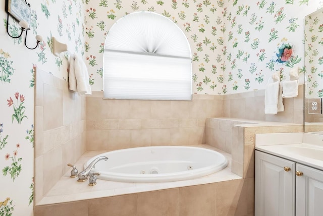 bathroom with vanity and a relaxing tiled tub