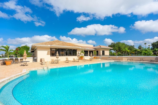 view of swimming pool featuring a patio