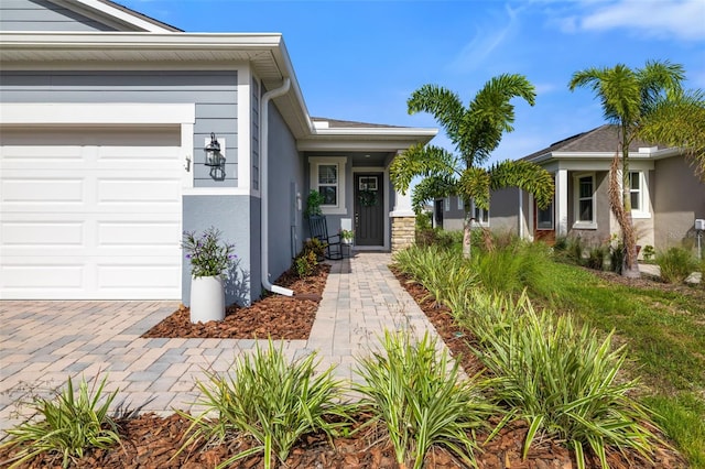 doorway to property with a garage