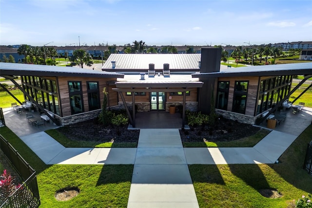 exterior space featuring french doors and a front lawn