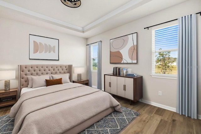 bedroom featuring light hardwood / wood-style floors and multiple windows