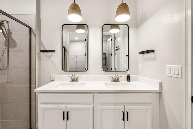 bathroom with vanity and a shower with door