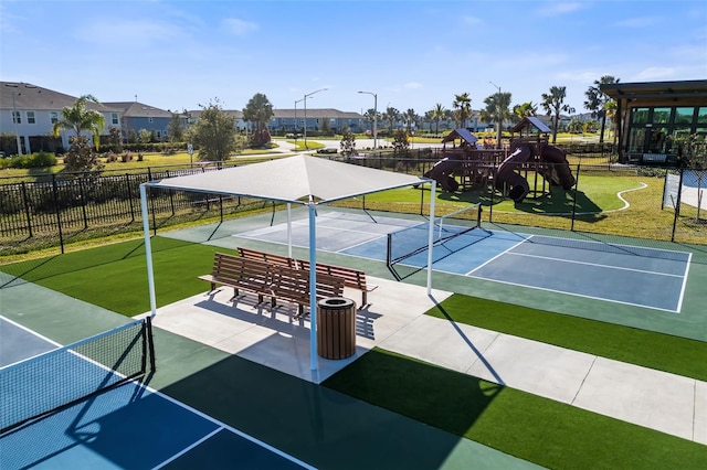 surrounding community with tennis court and a playground