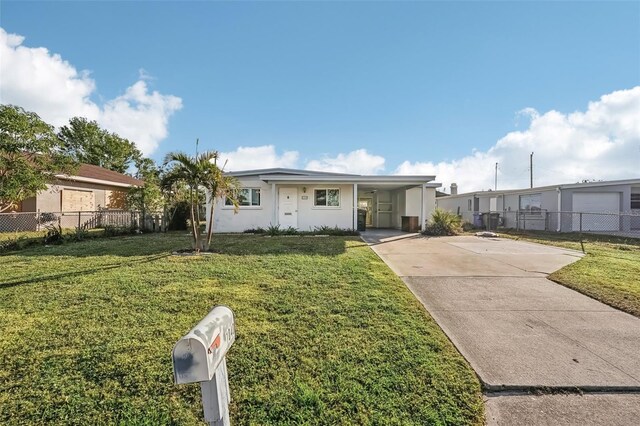 view of front of property featuring a front yard and a carport