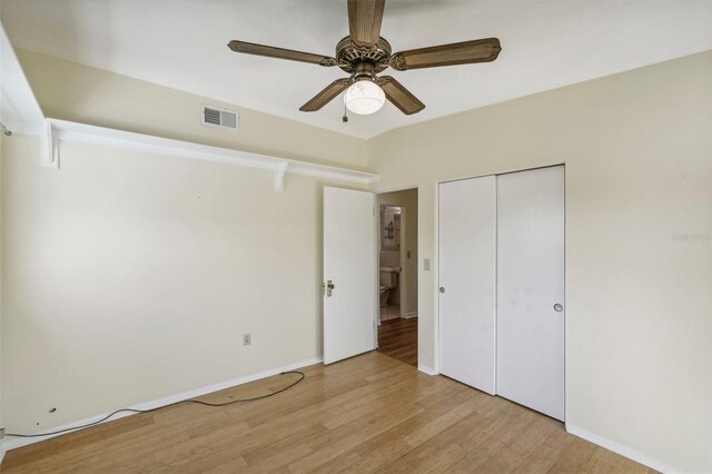 unfurnished bedroom with ceiling fan, a closet, and light hardwood / wood-style flooring