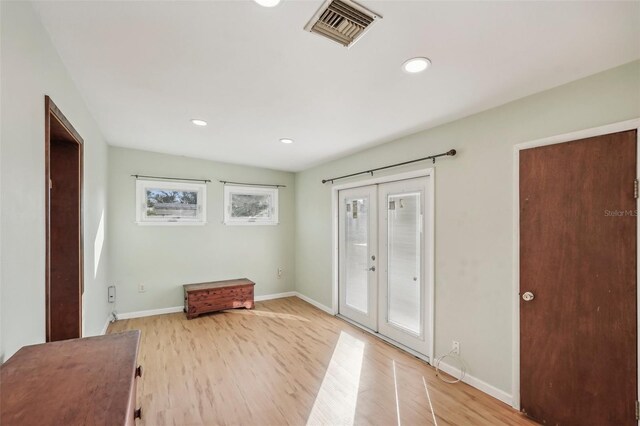 foyer featuring french doors and light hardwood / wood-style flooring