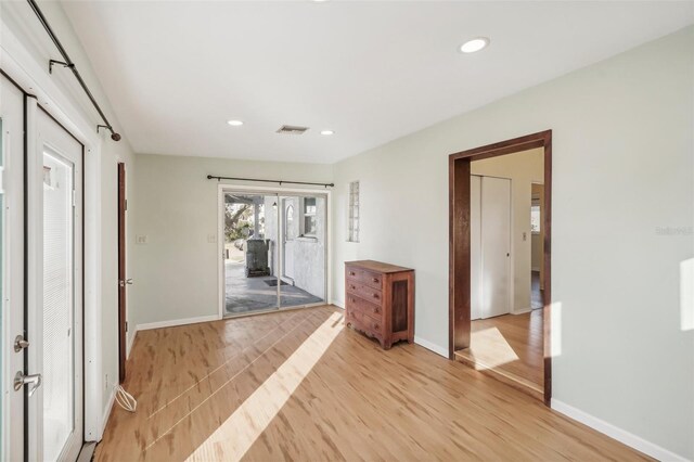 corridor featuring french doors and light hardwood / wood-style flooring