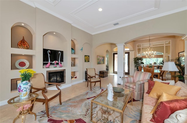 living room with built in shelves, ornate columns, a notable chandelier, crown molding, and light tile patterned flooring