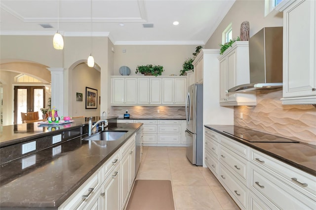 kitchen featuring sink, white cabinets, stainless steel appliances, and wall chimney range hood