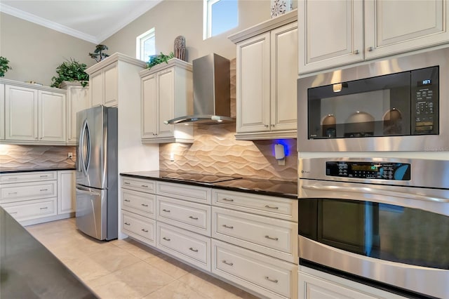 kitchen featuring decorative backsplash, appliances with stainless steel finishes, wall chimney exhaust hood, crown molding, and light tile patterned floors