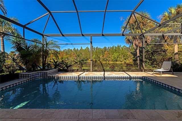 view of pool featuring glass enclosure and a patio area