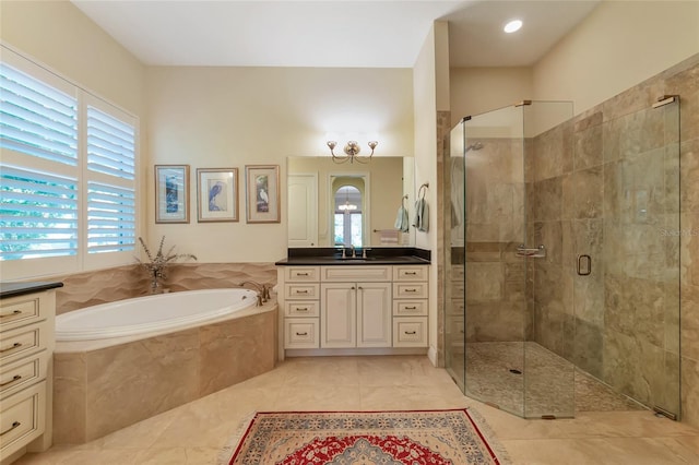 bathroom featuring tile patterned floors, plus walk in shower, and vanity