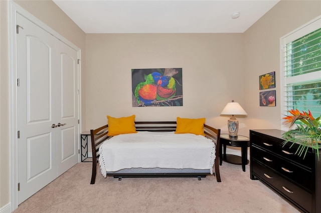 carpeted bedroom with a closet