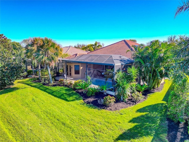 view of yard with a patio, a pool, and a lanai