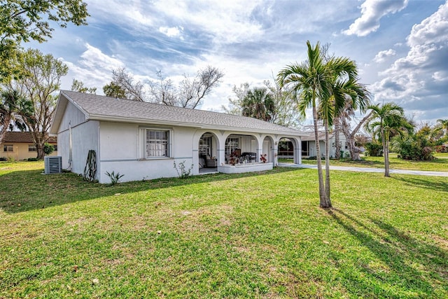 ranch-style house with a front lawn and central AC