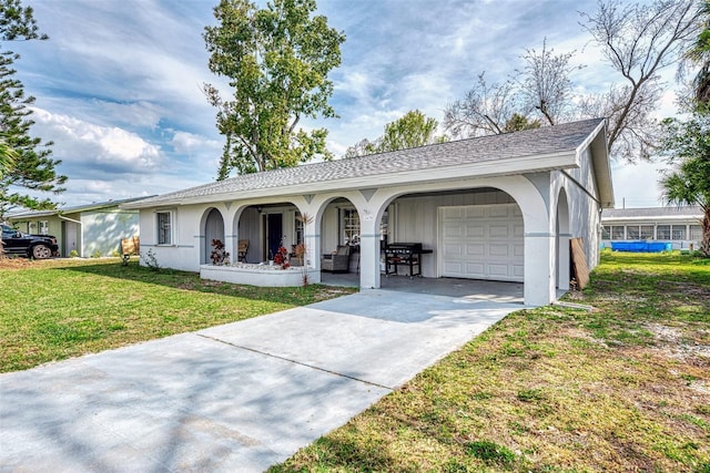 ranch-style house with covered porch, a front yard, and a garage