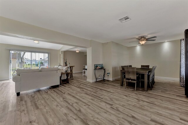 dining area with light hardwood / wood-style flooring and ceiling fan