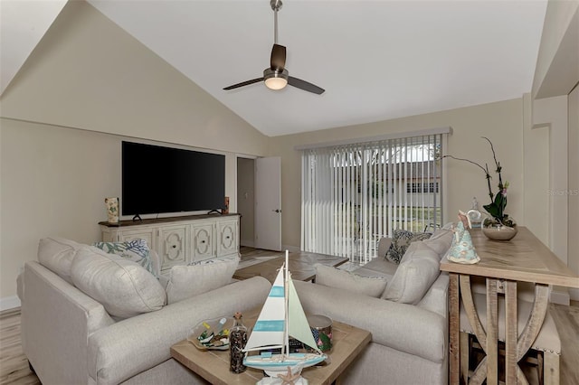 living room featuring light hardwood / wood-style floors, vaulted ceiling, and ceiling fan