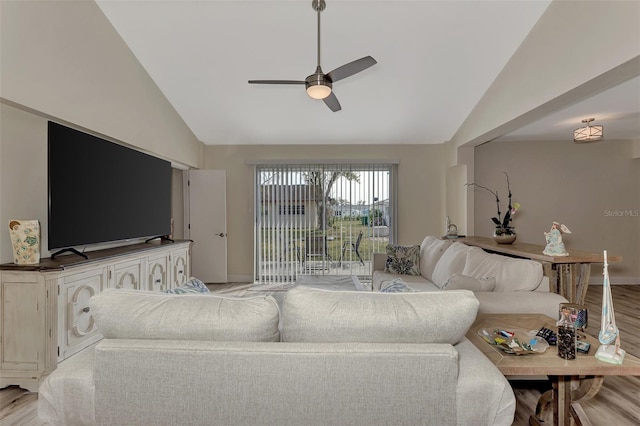 living room with light hardwood / wood-style flooring, ceiling fan, and lofted ceiling