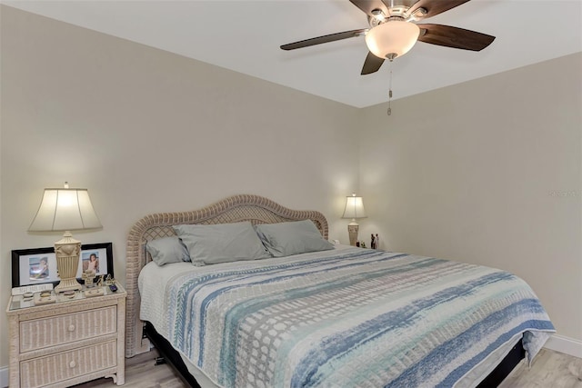 bedroom with ceiling fan and light wood-type flooring