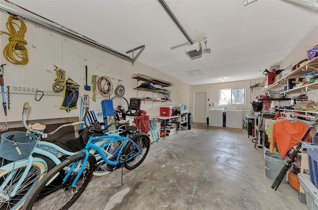 garage with washer and dryer and a garage door opener