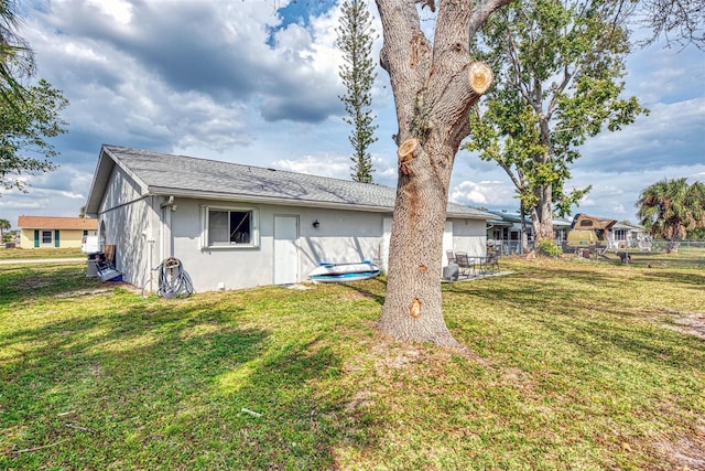 rear view of property featuring a yard