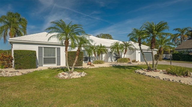 view of front of property with a garage and a front yard