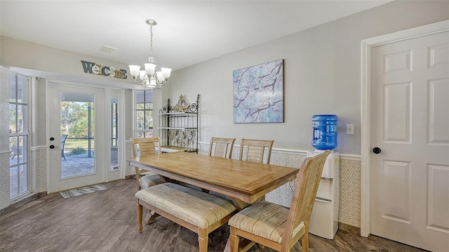 dining space featuring dark hardwood / wood-style floors and a notable chandelier