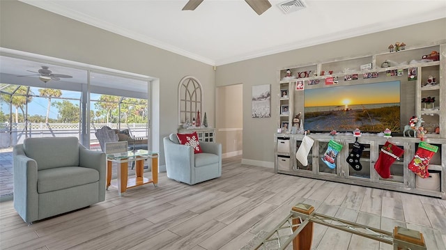 bedroom featuring ceiling fan, light wood-type flooring, and ornamental molding