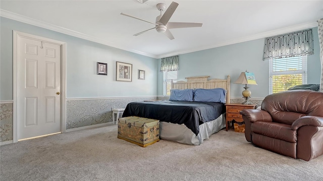 carpeted bedroom featuring ceiling fan, ornamental molding, and multiple windows