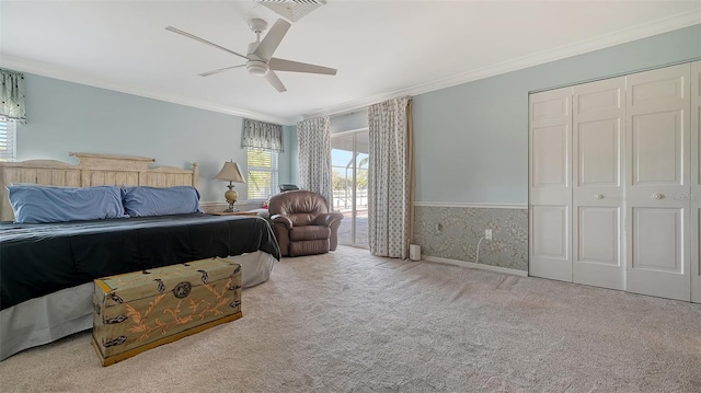 bedroom featuring light carpet, a closet, ceiling fan, and ornamental molding