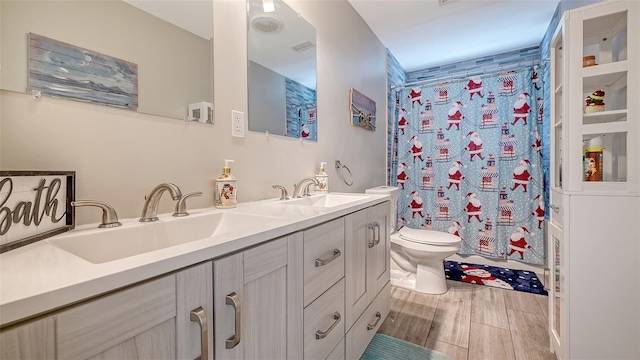 bathroom with curtained shower, toilet, vanity, and hardwood / wood-style flooring