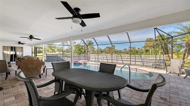 view of patio / terrace featuring a swimming pool with hot tub and a lanai