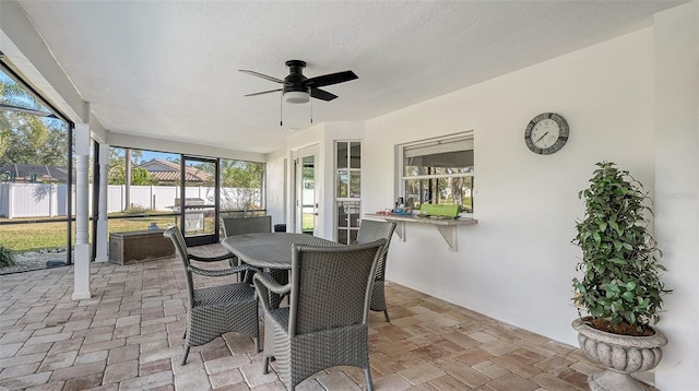 sunroom featuring ceiling fan